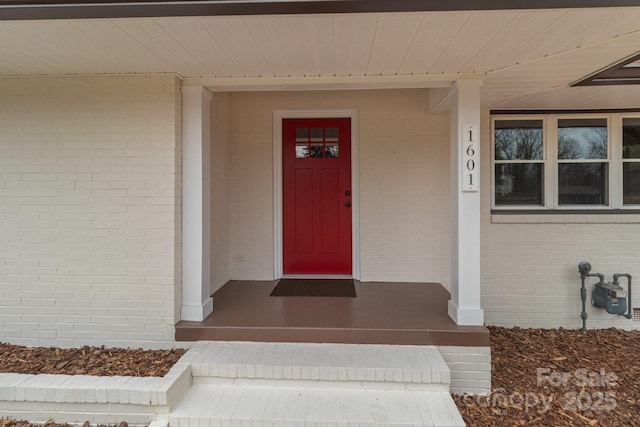 property entrance with brick siding