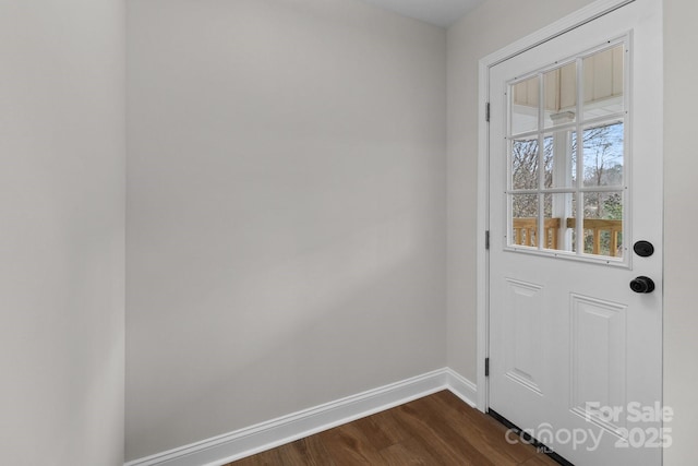 entryway featuring baseboards and dark wood-style flooring