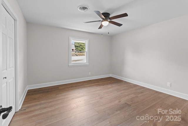 unfurnished bedroom featuring visible vents, ceiling fan, baseboards, wood finished floors, and a closet