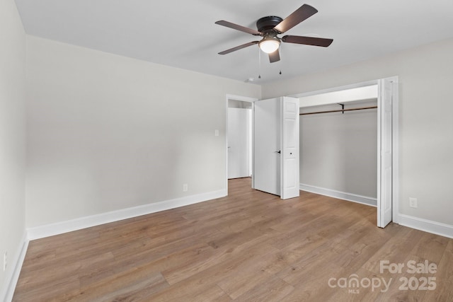 unfurnished bedroom featuring a closet, baseboards, a ceiling fan, and light wood finished floors