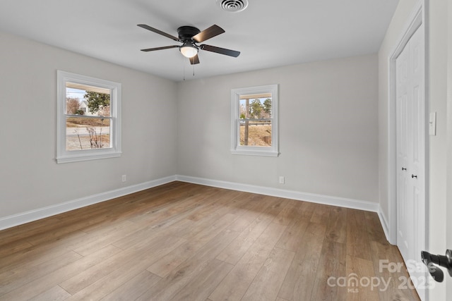 unfurnished bedroom with visible vents, baseboards, a closet, and wood finished floors