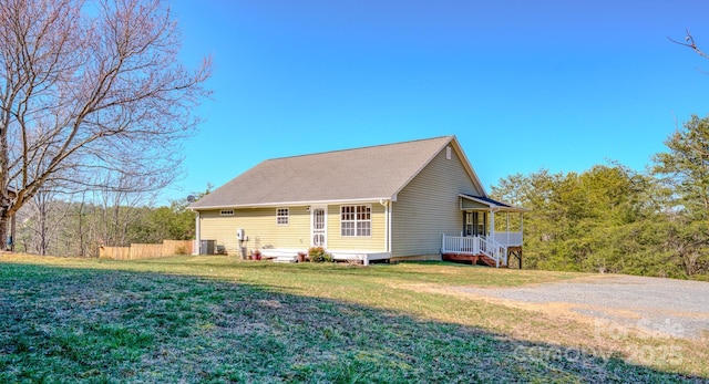 exterior space with a porch, central AC, a yard, and fence