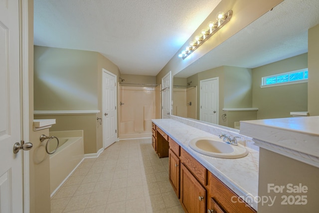 bathroom featuring vanity, baseboards, walk in shower, a textured ceiling, and a bath