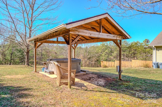 view of yard featuring a gazebo, fence, and a hot tub