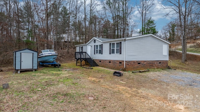 view of property exterior with a storage shed, an outbuilding, a lawn, and crawl space