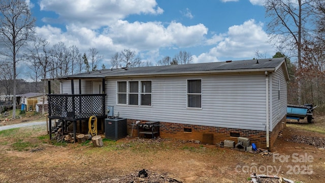 rear view of house with crawl space and central air condition unit