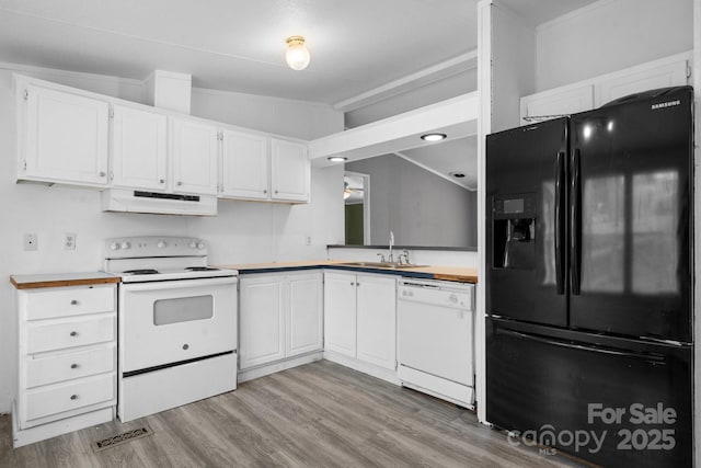 kitchen with visible vents, under cabinet range hood, white cabinets, white appliances, and a sink