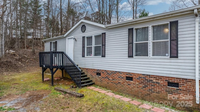 view of side of home with crawl space