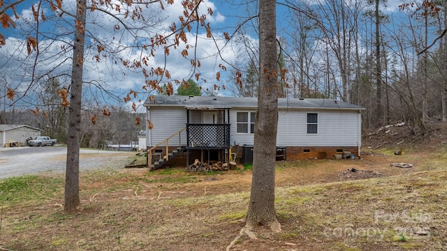 rear view of house featuring crawl space