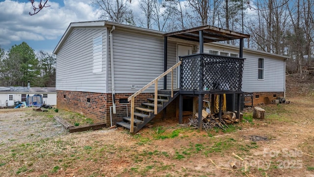 back of house with crawl space, stairway, and a deck