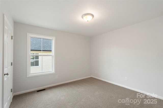 spare room featuring visible vents, baseboards, and carpet floors