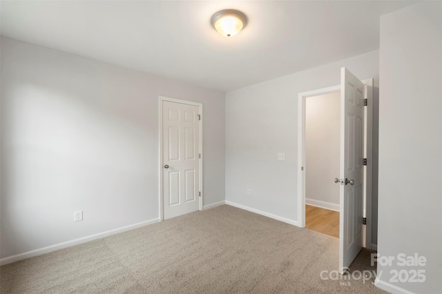 unfurnished bedroom with carpet and baseboards