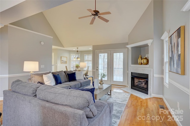 5306 Club View Dr, Concord, NC 28025 - living room featuring high vaulted ceiling, a high end fireplace, light wood-style floors, and a ceiling fan
