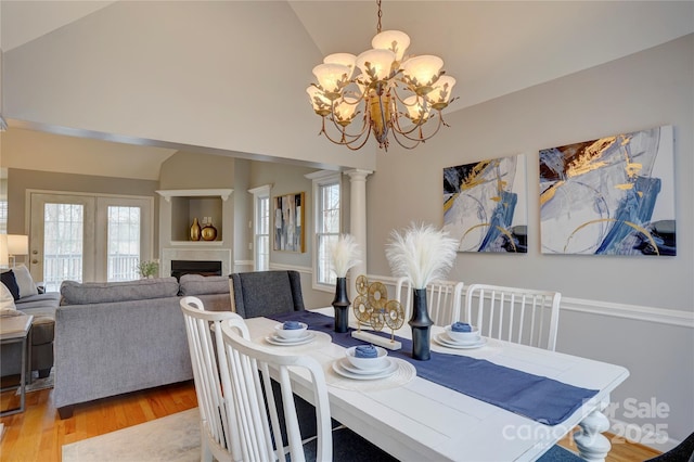 5306 Club View Dr, Concord, NC 28025 - dining area with a chandelier, light wood finished floors, a fireplace, and high vaulted ceiling