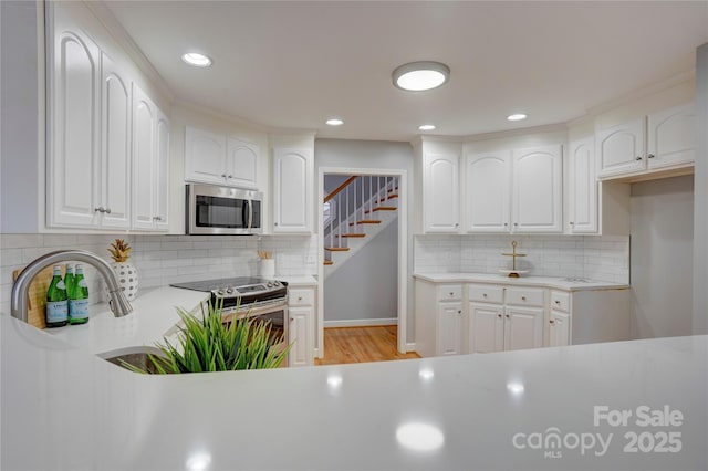 5306 Club View Dr, Concord, NC 28025 - kitchen with appliances with stainless steel finishes, decorative backsplash, light countertops, and recessed lighting
