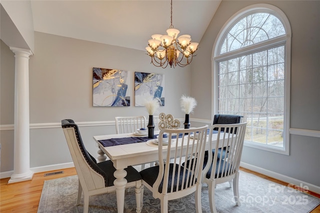 5306 Club View Dr, Concord, NC 28025 - dining area with plenty of natural light, a chandelier, light wood-style flooring, lofted ceiling, and decorative columns