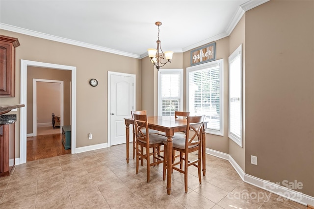 dining space with ornamental molding, light tile patterned flooring, baseboards, and a chandelier