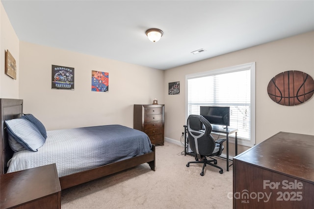 bedroom with visible vents, baseboards, and light colored carpet