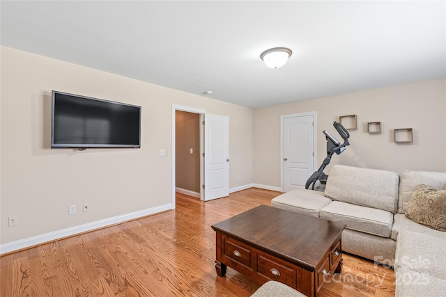 living room with light wood-type flooring and baseboards