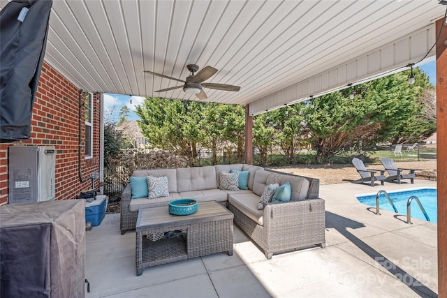 view of patio with a ceiling fan, a fenced in pool, and an outdoor hangout area