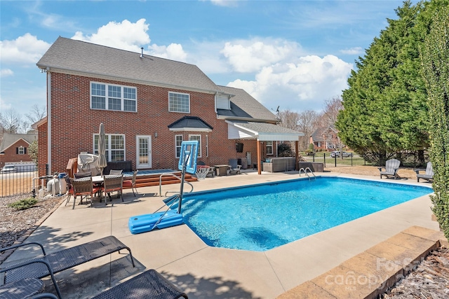 view of pool with a fenced in pool, fence, and a patio area