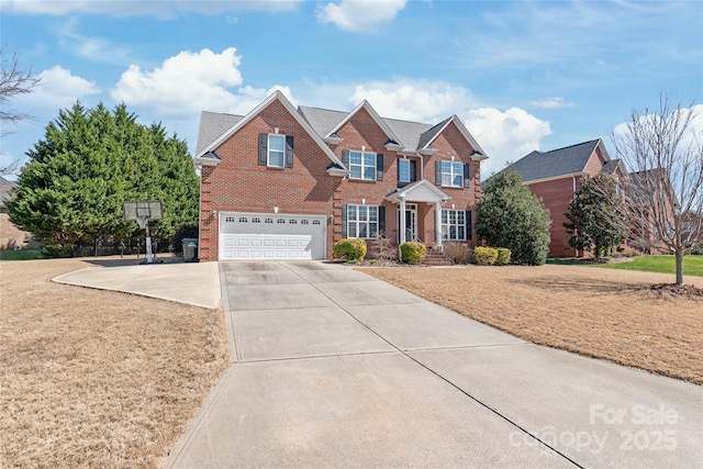 view of front of home with concrete driveway, an attached garage, and brick siding