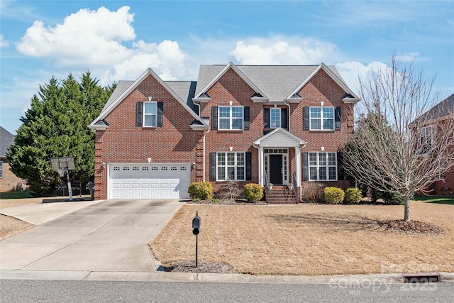 view of front of property with brick siding, a garage, and driveway