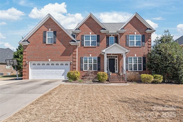 view of front of house featuring brick siding, an attached garage, concrete driveway, and a front yard