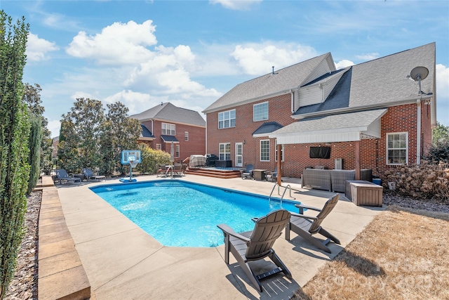 pool featuring an outdoor hangout area, a hot tub, and a patio area