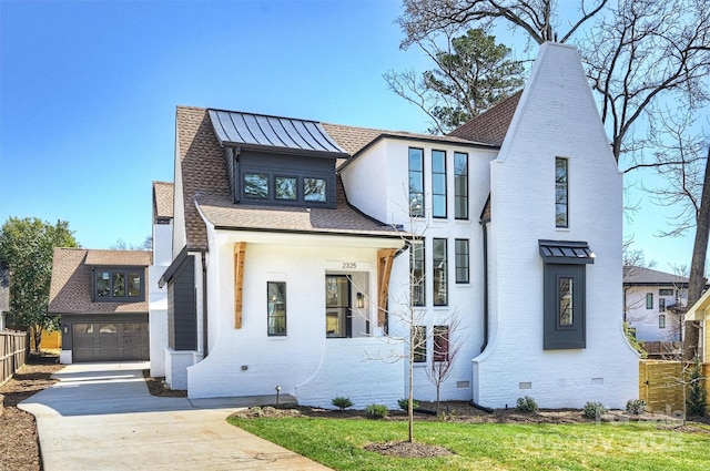 modern inspired farmhouse featuring a standing seam roof, a shingled roof, a garage, crawl space, and brick siding