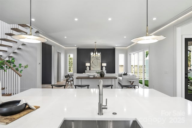 kitchen with decorative light fixtures, open floor plan, recessed lighting, and light countertops