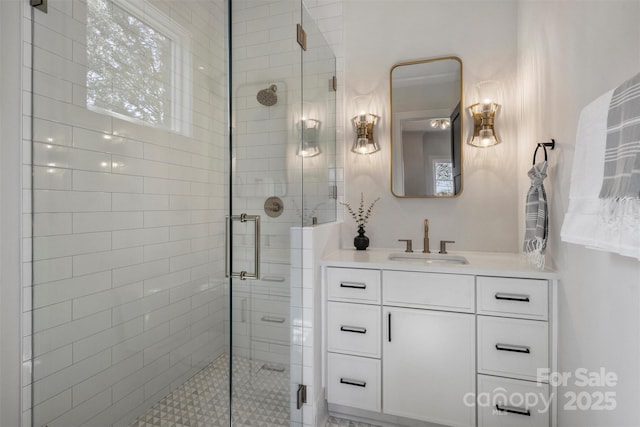 bathroom with a shower stall and vanity
