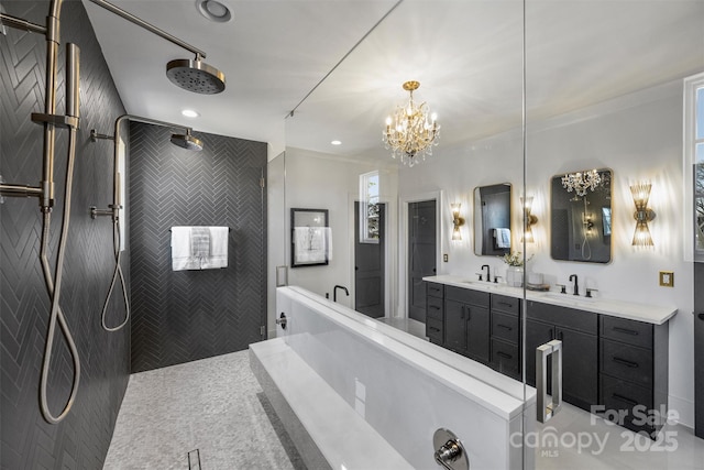 bathroom with vanity, a soaking tub, a walk in shower, and a chandelier