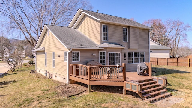back of house with fence, a yard, a wooden deck, a shingled roof, and crawl space