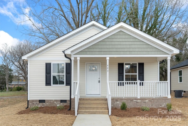 bungalow-style house featuring crawl space, a porch, and central AC