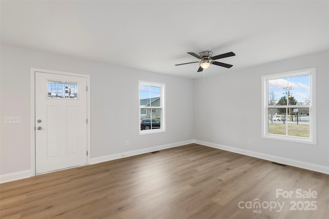 entryway featuring a wealth of natural light, baseboards, and wood finished floors