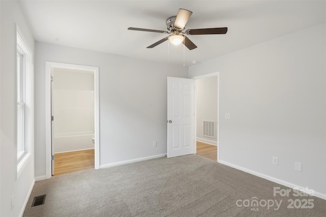 unfurnished bedroom with visible vents, baseboards, and carpet