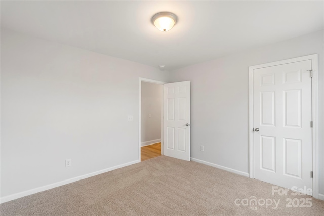 unfurnished bedroom with baseboards and carpet