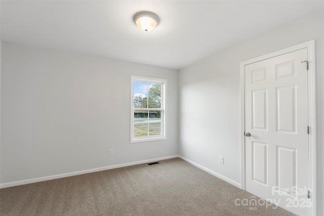 unfurnished room featuring visible vents, baseboards, and carpet floors