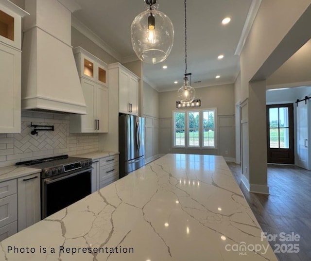 kitchen with glass insert cabinets, crown molding, custom range hood, appliances with stainless steel finishes, and white cabinets