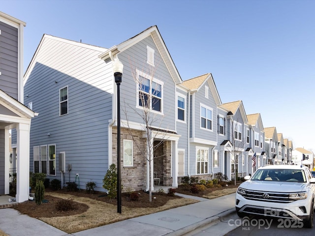 view of front facade featuring a residential view and stone siding