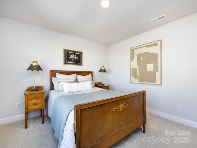 bedroom with visible vents, light carpet, and baseboards