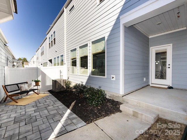 view of patio / terrace with central AC unit and fence