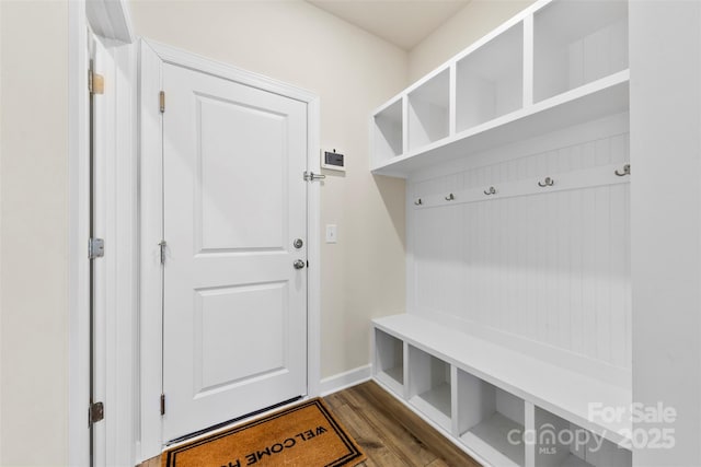 mudroom with dark wood-style floors and baseboards