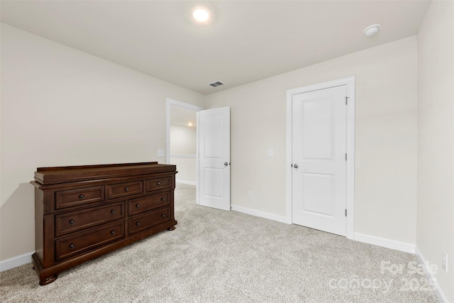 bedroom with light colored carpet, visible vents, and baseboards