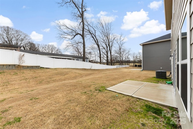 view of yard featuring a patio, central AC, and fence