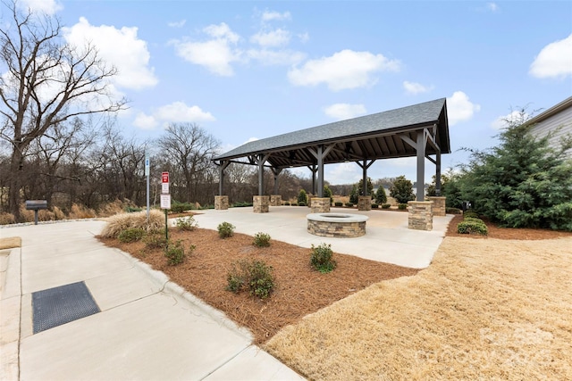 view of home's community with a gazebo, a patio area, and a fire pit