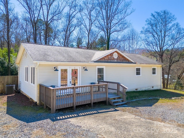 view of front of home with roof with shingles, central AC unit, french doors, a deck, and crawl space