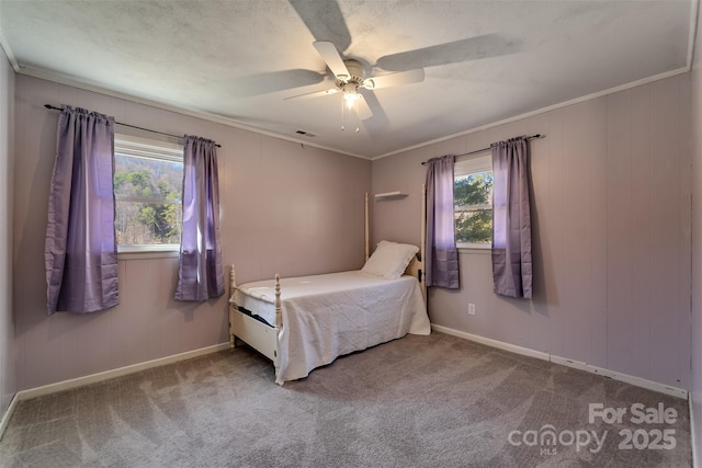 unfurnished bedroom featuring carpet flooring, a ceiling fan, crown molding, and visible vents