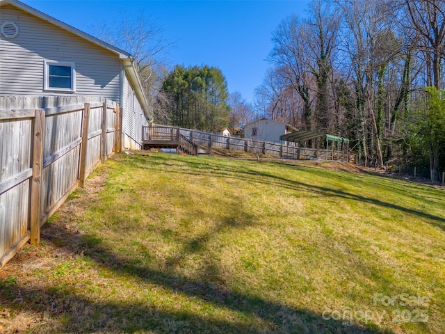 view of yard featuring a wooden deck and fence